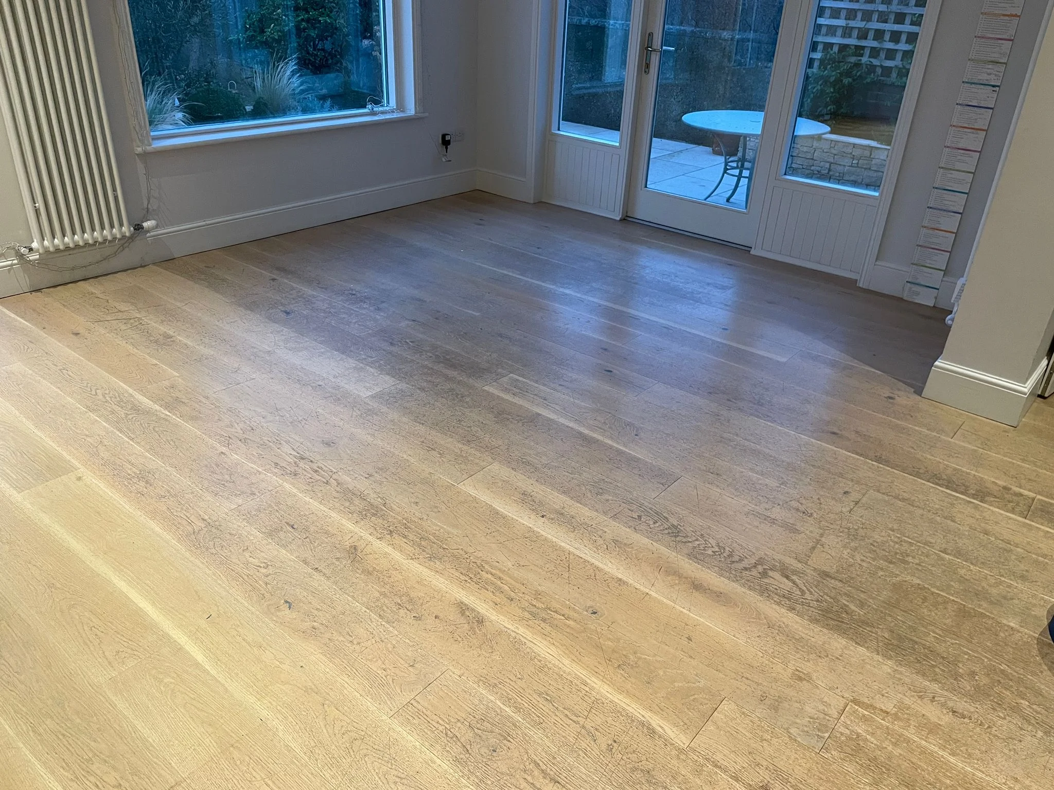 A picture of a white wooden floor perfectly sanded and with a nice coat of staining.