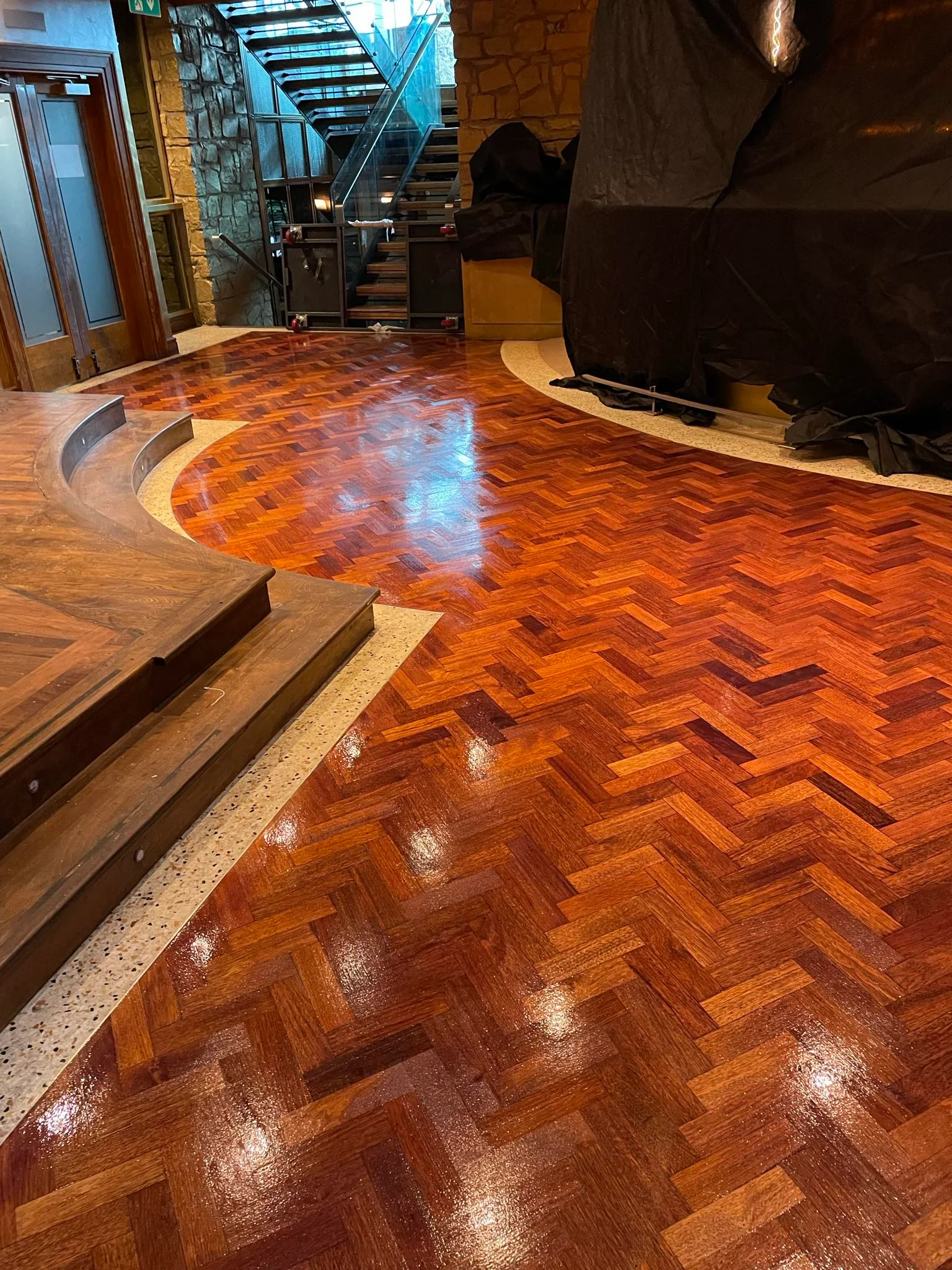 A business with semi-solid wooden floor sanded & stained.