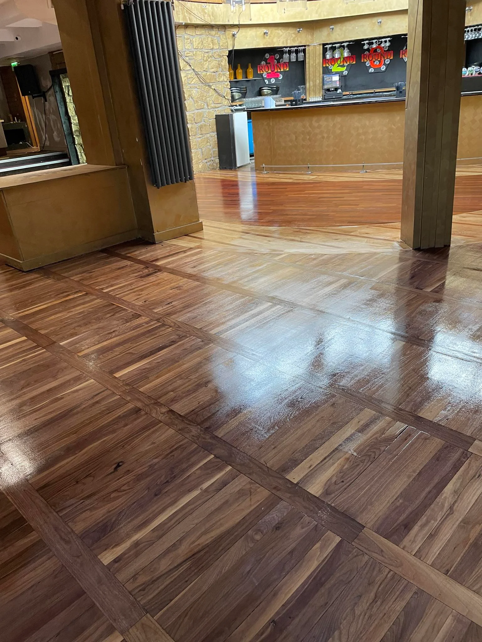 A business with solid wooden floor sanded & stained.