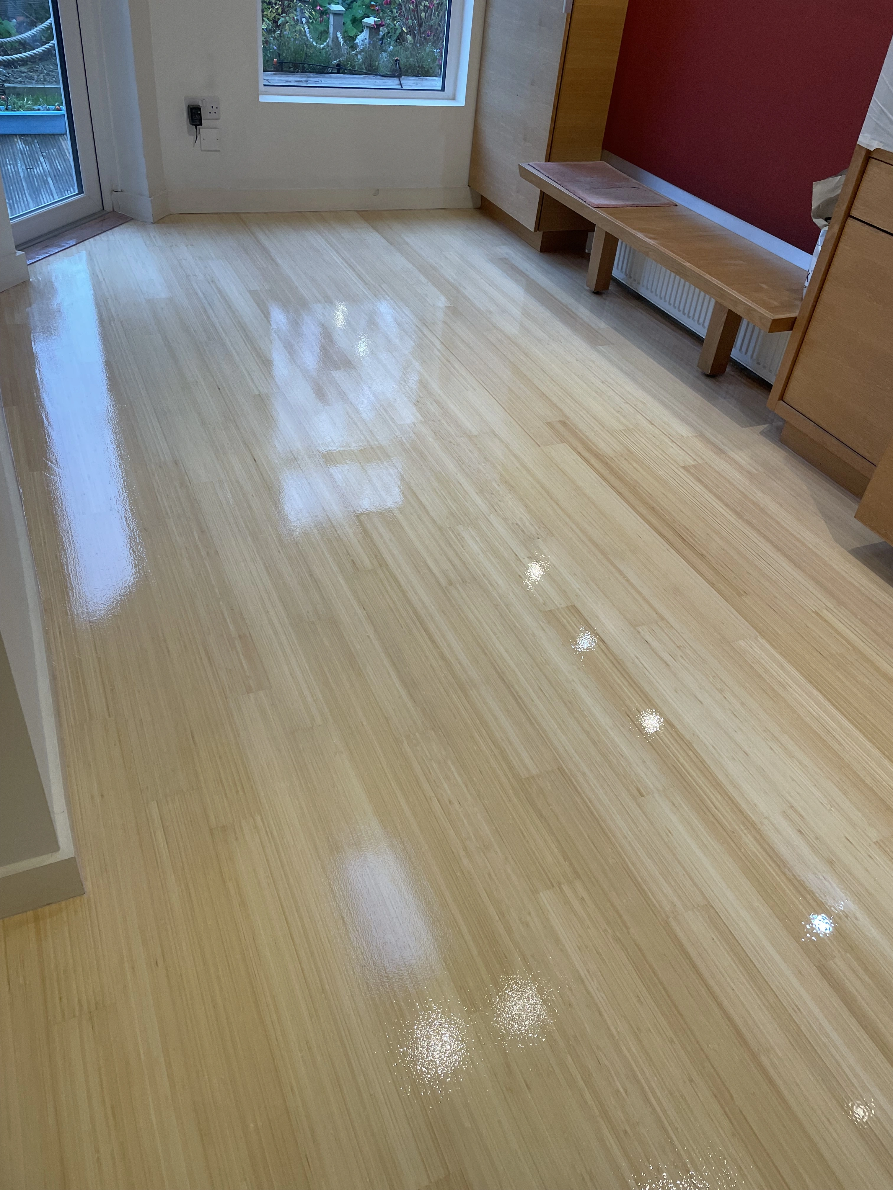 A semi-solid wooden floor sanded & stained.