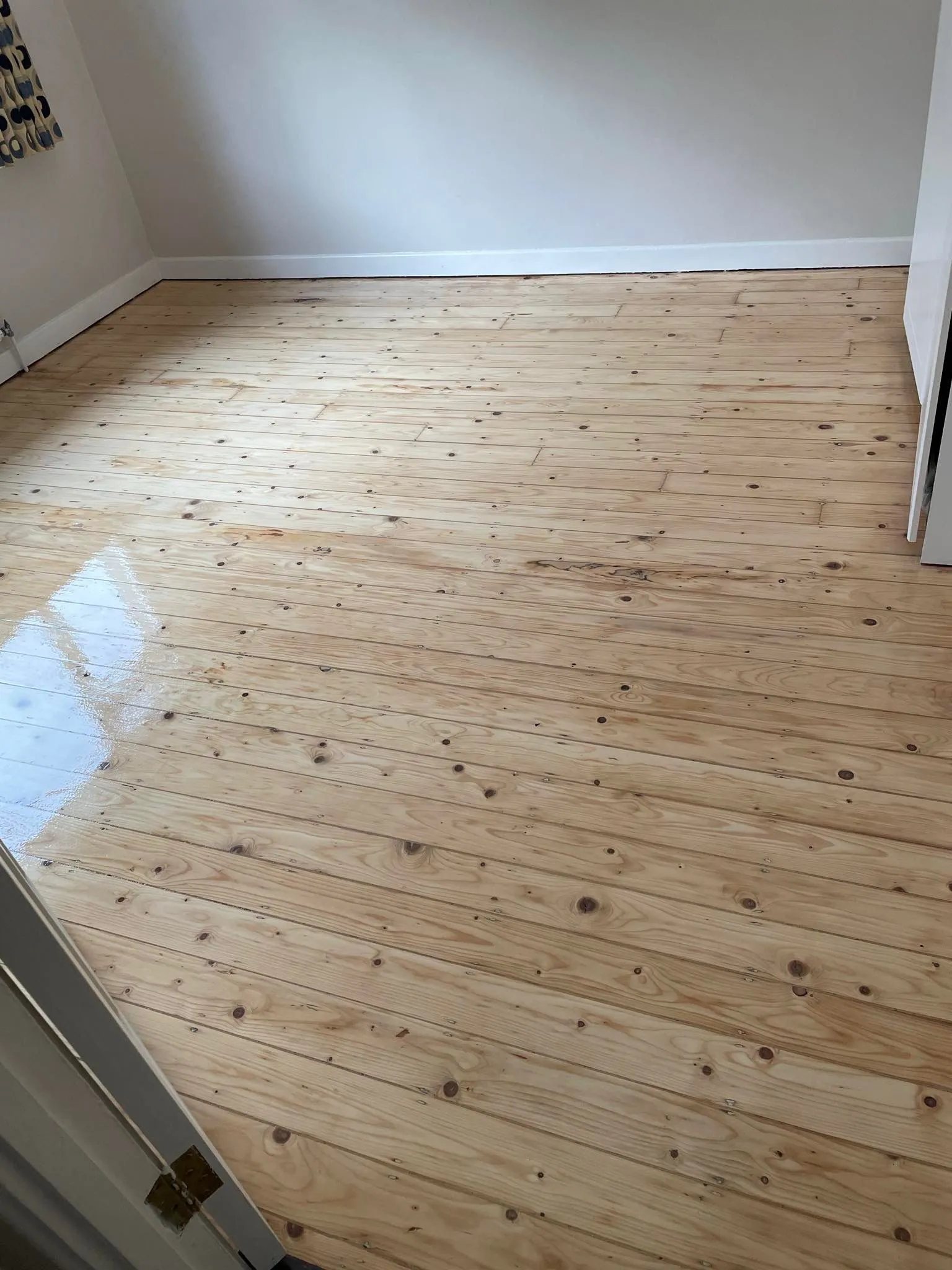 A semi-solid wooden floor half sanded.1