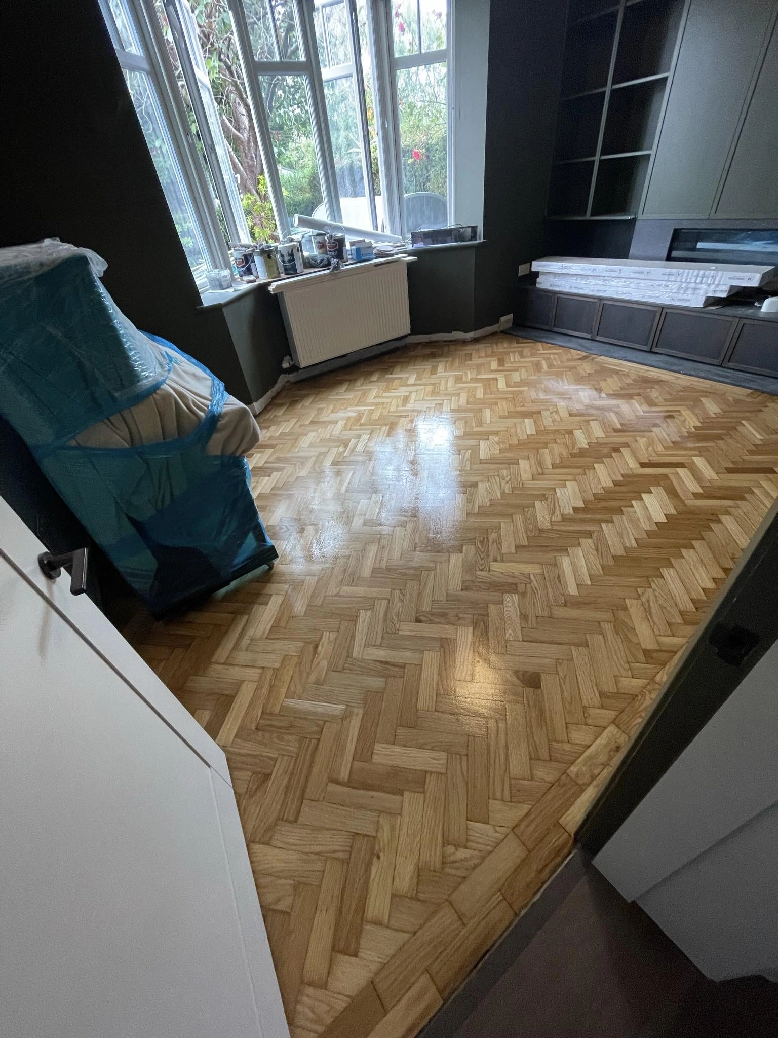 A semi-solid wooden floor with wooden decorations sanded & stained.