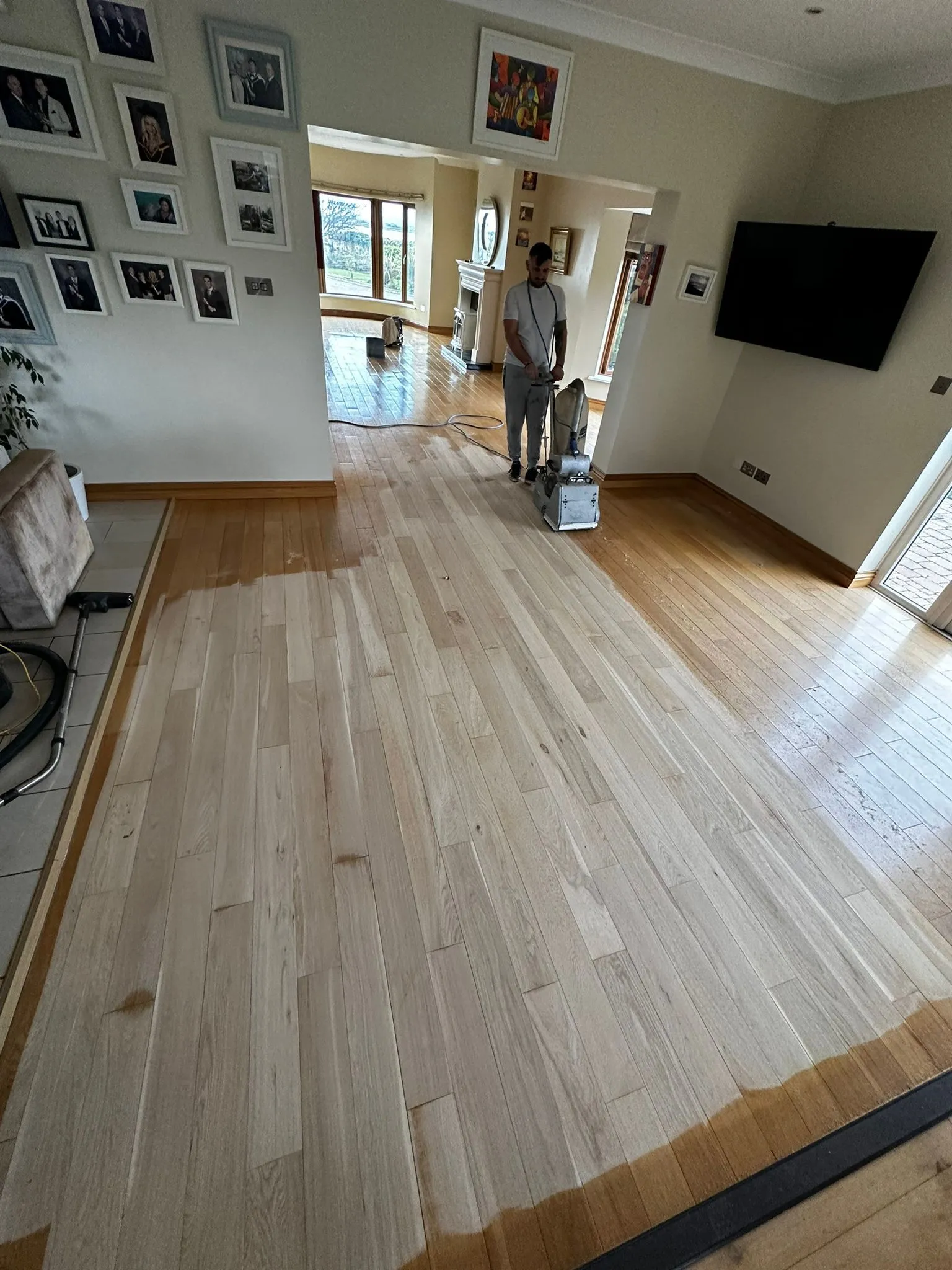 Alin with half sanded wooden floor.