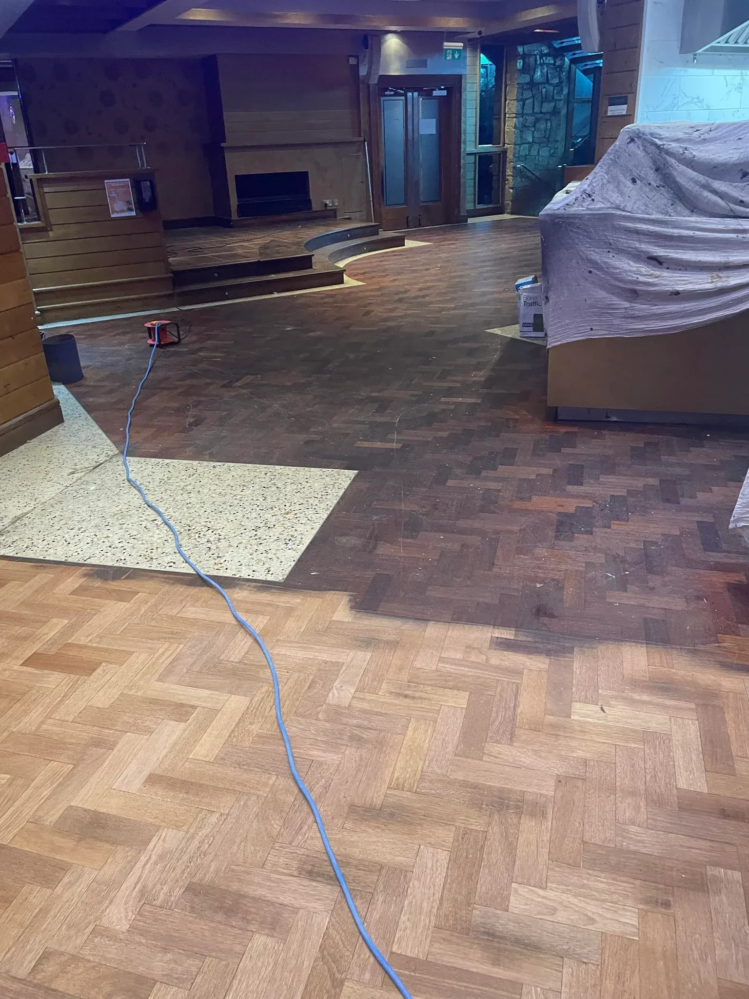 Business with half sanded wooden floor.