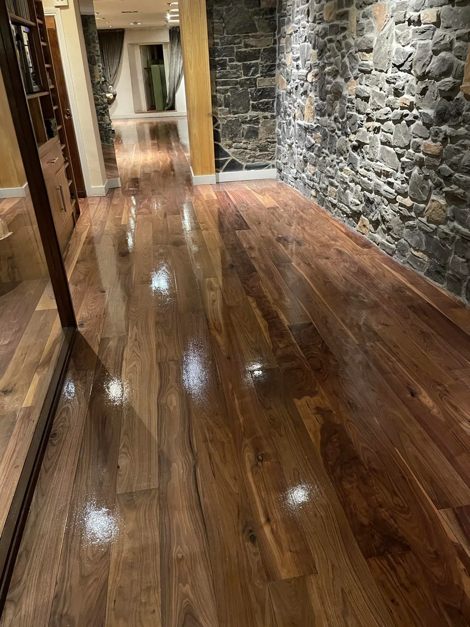 Pub with floor sanded & stained with accent stone wall.