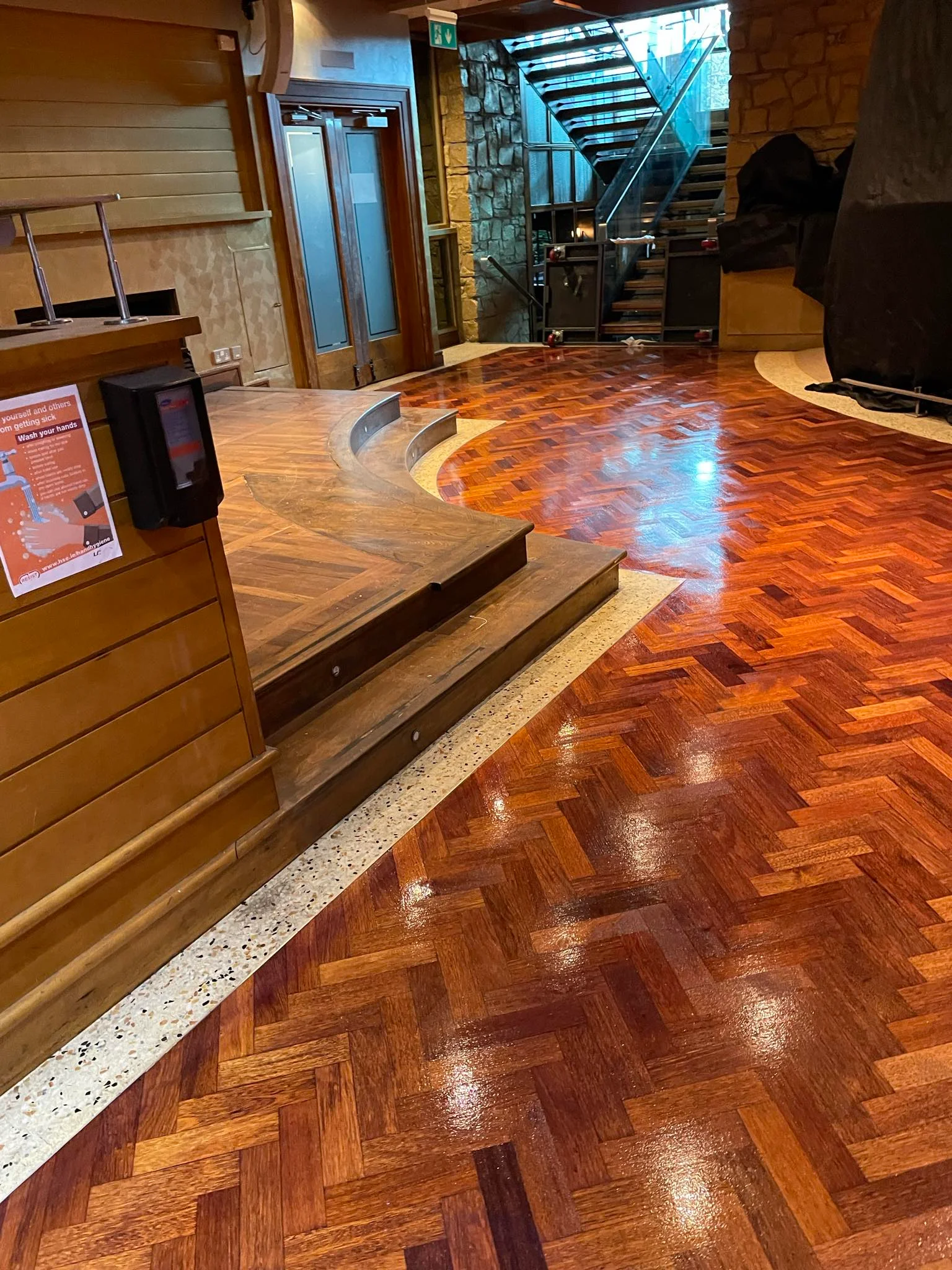 A business with a decorated wooden floor sanded & stained.