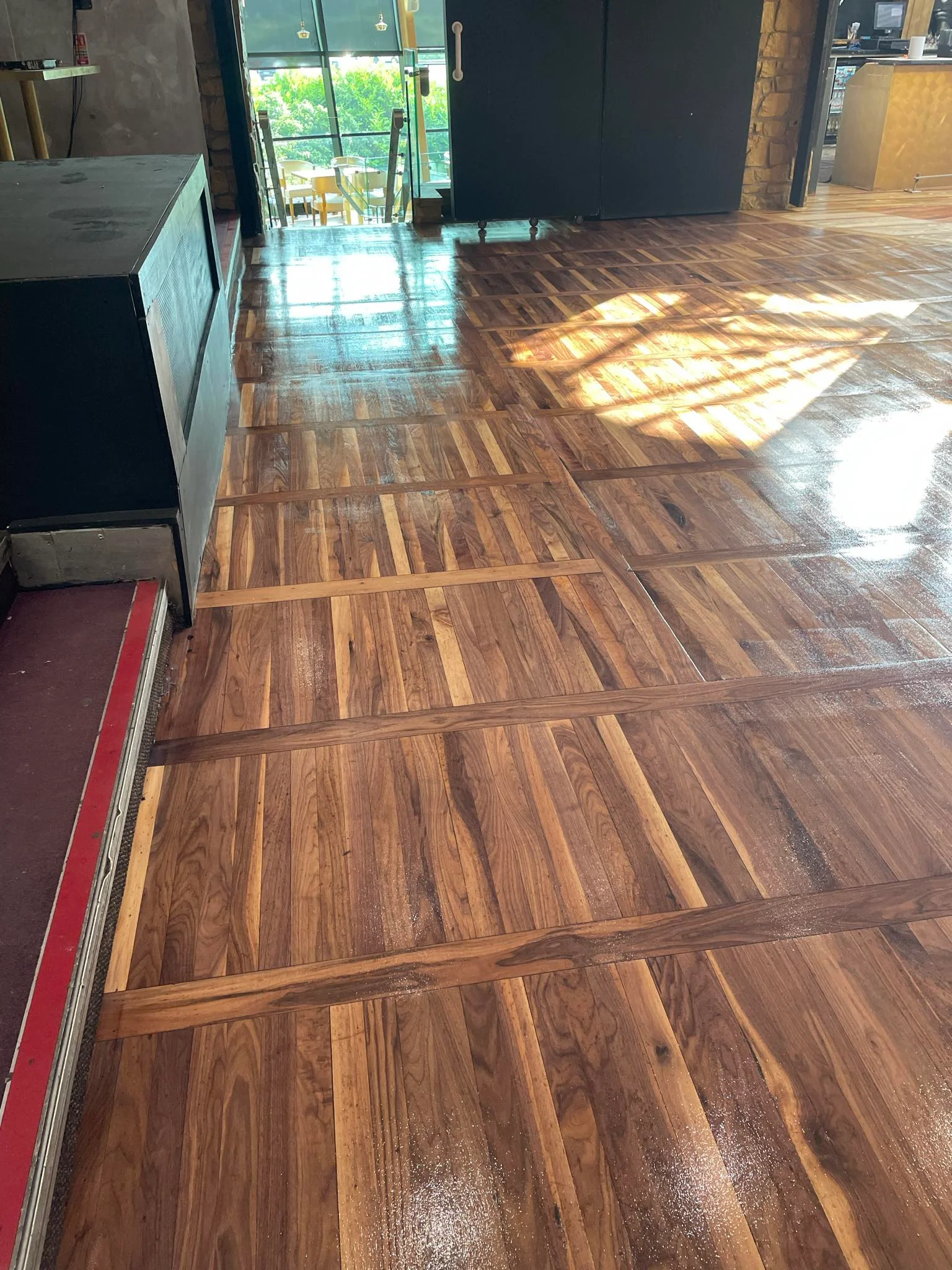 A floor in a company after the sanding & staining process.