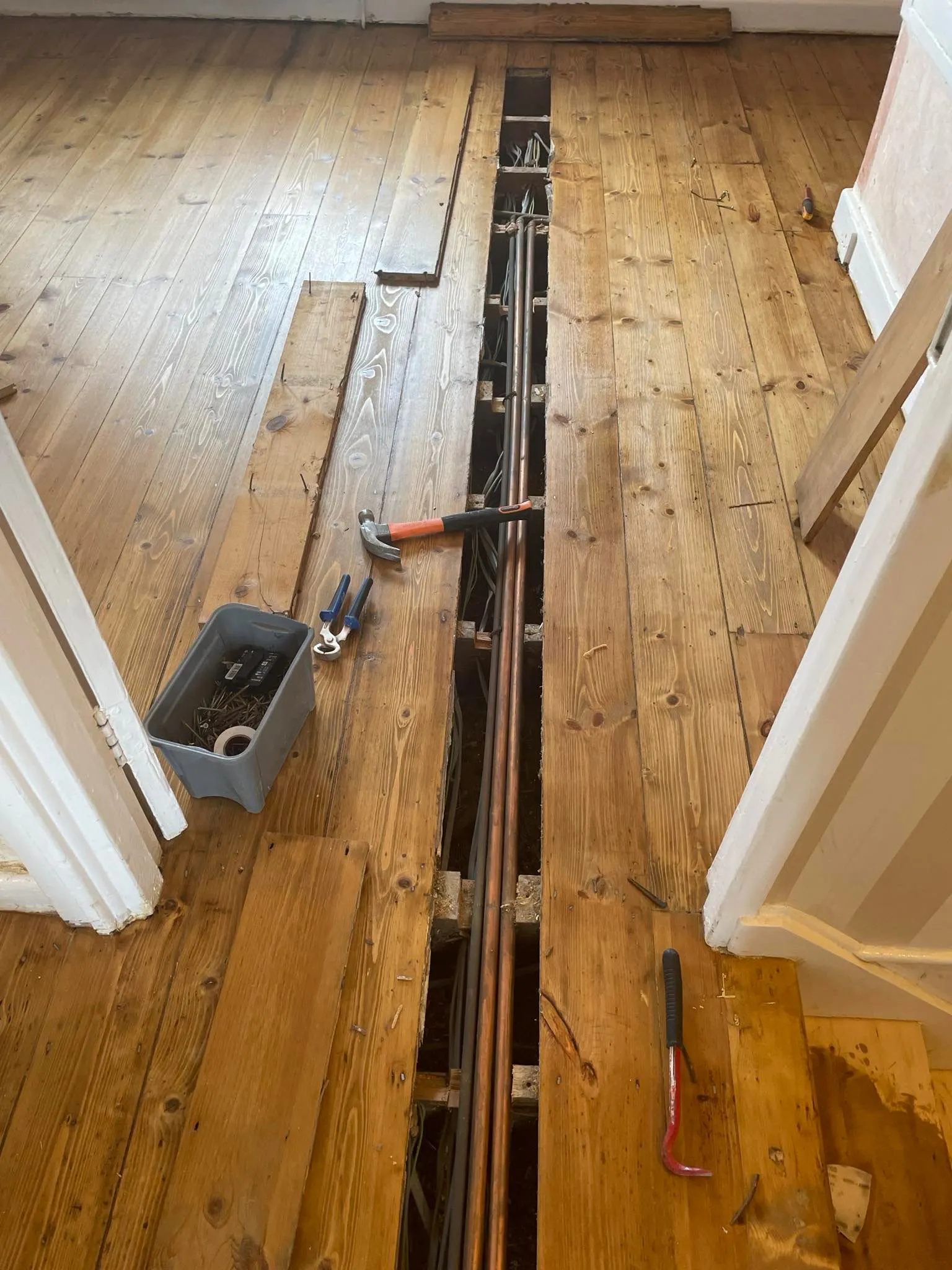 A wooden floor in repairing process with a gap of floor plank.