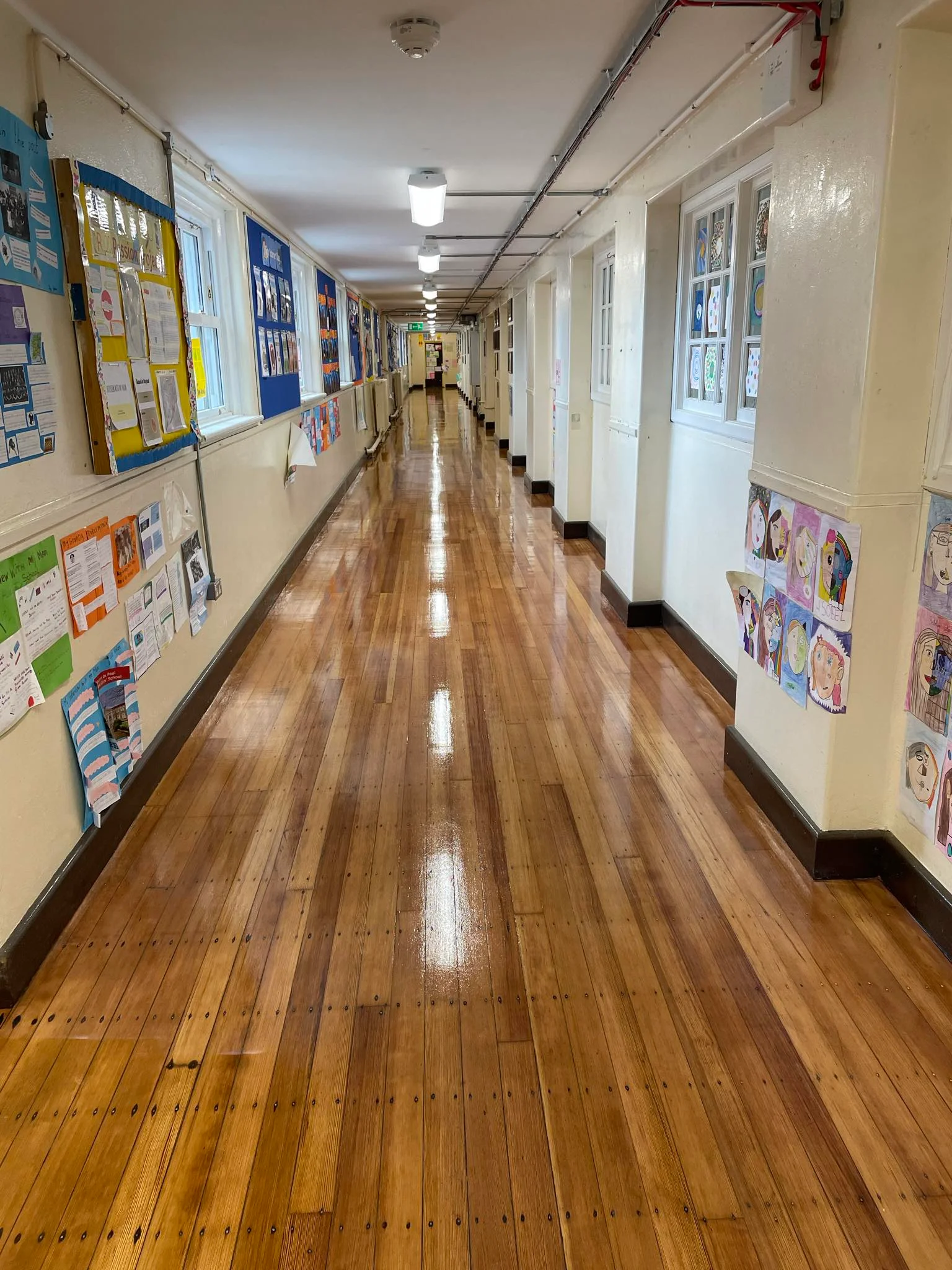 A school corridor perfectly sanded & stained with a nice light brown coat.